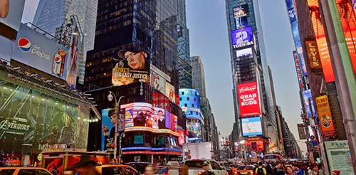 Lots of buildings with digital signs on them